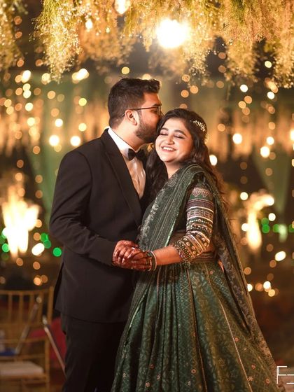 A classic, heartfelt moment. The groom's gentle kiss on the bride's forehead is a timeless expression of love. I captured this candidly during their sangeet, with the festive lights creating a beautiful bokeh effect.