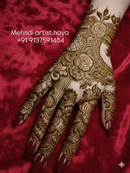 A close-up of a floral bridal design on the back of the hand. The raised paste shows the precision of the line work and the 3D effect before it dries and stains the skin.