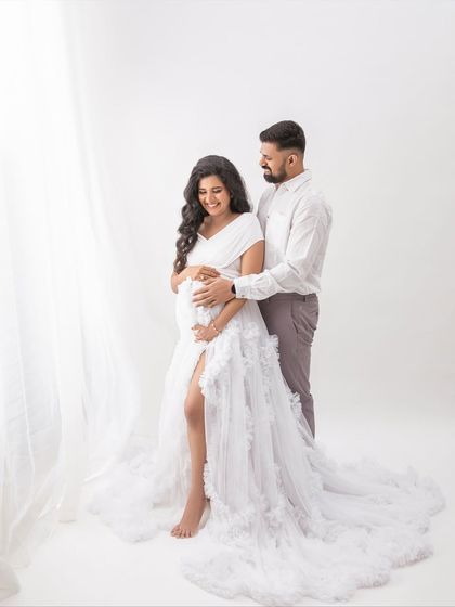 Standing by the soft light of the window, this portrait has a beautiful, airy feel. A timeless image of a couple waiting for their baby.