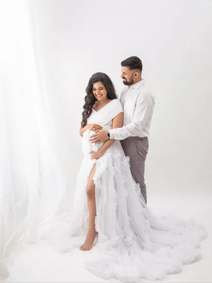Standing by the soft light of the window, this portrait has a beautiful, airy feel. A timeless image of a couple waiting for their baby.