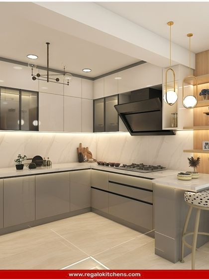 A stylish L-shaped kitchen with a small breakfast nook. The design features grey cabinets, a marble-patterned backsplash, and modern pendant lights, creating a functional and sociable cooking space.