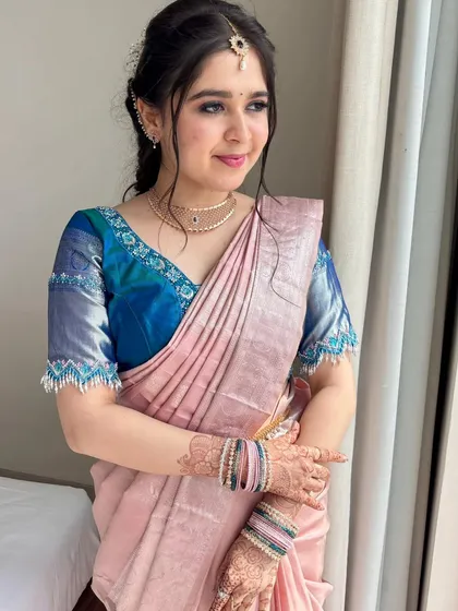 A candid moment showcasing her radiant skin and the intricate details of her henna.