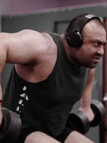 Training back with heavy dumbbell rows. A strong back is the foundation of a big deadlift.