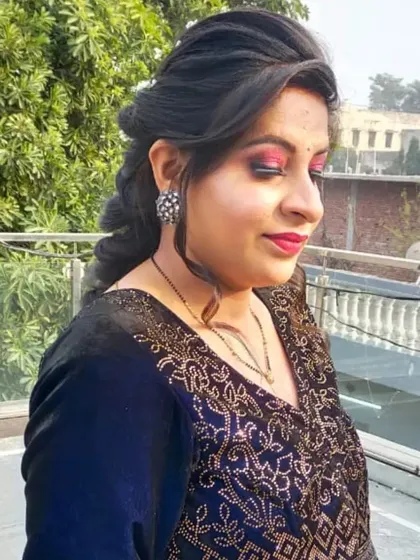 A soft glam makeup look with a focus on a shimmering pink eyeshadow and a classic red lip. The braided hairstyle is perfect for keeping hair manageable during a long event.