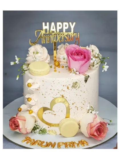 A stunning anniversary cake decorated with fresh roses, macarons, and gold leaf. This fresh pineapple cake is both elegant and delicious.