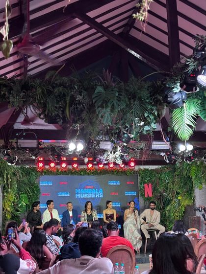 A wide shot of the intimate press event for 'Mandala Murders'. We manage events of all scales, from massive auditoriums to smaller, themed venues.