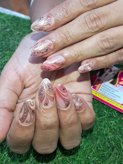 An incredibly detailed and luxurious design featuring intricate patterns, glitter, and pearl embellishments.