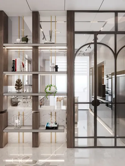 We designed this open shelving unit to act as a stylish partition, separating the kitchen from the living area. The combination of an exposed brick pillar, glass shelves, and arched metal-framed doors adds an industrial-chic element while maintaining a light and open feel.