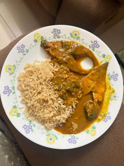 A simple and satisfying dinner of brown rice with a generous serving of fish curry.