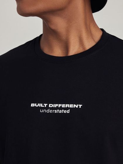 A close-up shot of a t-shirt from streetwear brand Understated, focusing on the minimalist branding.