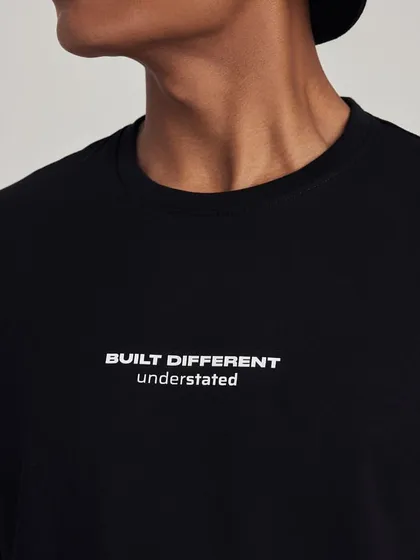 A close-up shot of a t-shirt from streetwear brand Understated, focusing on the minimalist branding.