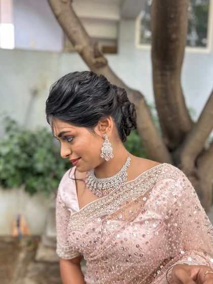 A side profile of the client, showing how the soft updo complements her features.