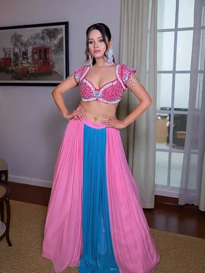 A full-length view showing how the sleek high ponytail balances the flowing lehenga, creating a look that is both elegant and ready for the dance floor.