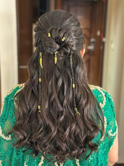 A closer look at the boho-chic details, including the knotted half-up section and scattered accessories.