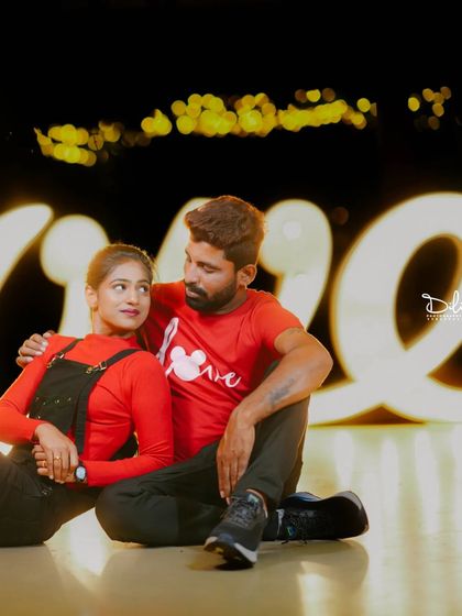 A fun and casual moment with the large, illuminated 'Love' sign.