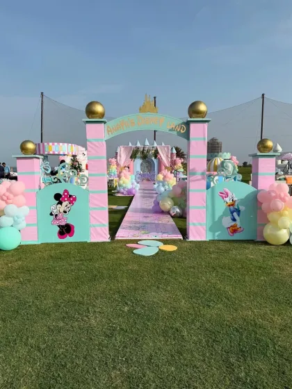 The grand entrance to the Mickey and Minnie magical kingdom, with a custom archway and a colorful pathway leading to the main event.