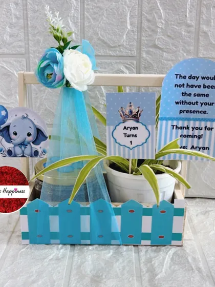Announce your baby boy with this adorable blue-themed favor. It includes a plant, treats, and a personalized card featuring a cute elephant and a thank you message from baby Aryan.
