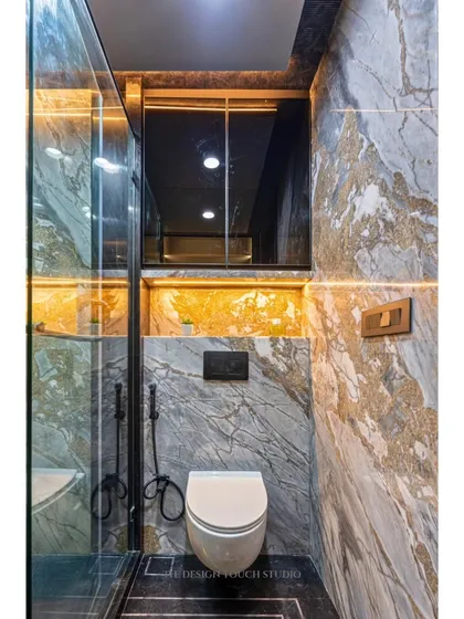 This view shows the floating toilet with a concealed flush tank, a space-saving solution that enhances the modern, clean look of the bathroom.