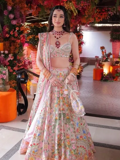 The full Abu Jani Sandeep Khosla lehenga, a masterpiece of color and embroidery. The makeup is kept soft and romantic to complement the outfit.