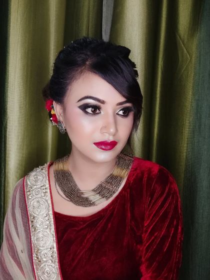 A side profile of this elegant look, showing the soft updo with a flower.