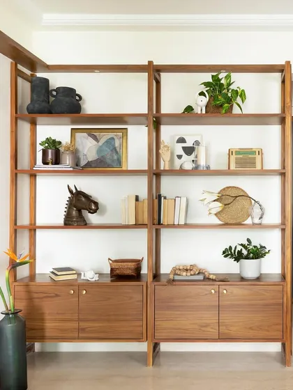 A modular open-shelf display unit with integrated base cabinets, offering a flexible and stylish solution for storage and decor.