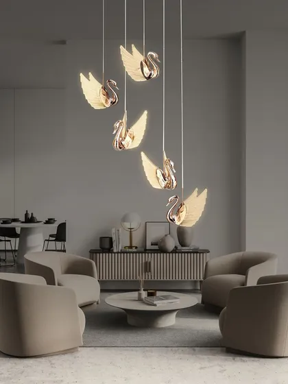 I love offering unique pieces like this rose gold swan chandelier. It's a very elegant design where each swan appears to float, creating a beautiful cascading effect. This is perfect for adding a touch of art to a living room or a tall corner space.