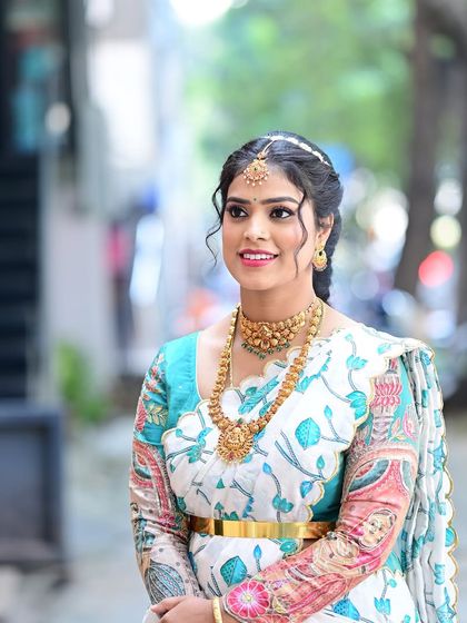 A lovely three-quarter shot of Preethi, capturing the grace and happiness of the occasion.