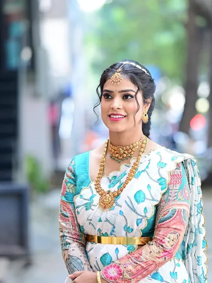 A lovely three-quarter shot of Preethi, capturing the grace and happiness of the occasion.