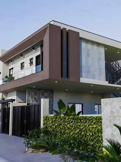A look at one of our modern architectural designs. This concept balances bold geometric shapes with natural elements like stone cladding and integrated greenery, creating a striking and sophisticated exterior for a contemporary family home.