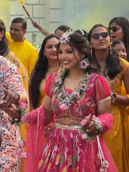 A candid shot of the bride during her Haldi ceremony. The natural makeup ensures she looks fresh and beautiful throughout the event, even with all the dancing and fun.