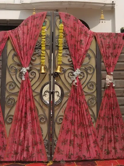 The entrance to the 25th anniversary Haldi celebration was decorated with beautiful printed drapes and marigold garlands, creating a warm and traditional welcome.