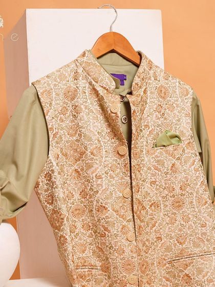 This embroidered vest, paired with an olive green kurta, is a perfect example of how to layer colors and textures for a rich, festive look.