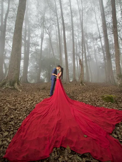 A fairytale moment captured in a misty Kodaikanal forest. I love creating these dramatic, cinematic shots, especially when couples are open to bold ideas like this flowing gown that adds a splash of color to the natural scenery.
