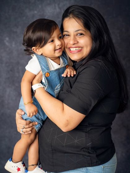 A big, happy squeeze from mom. This photo is full of laughter and love, showcasing the fun and joyful side of family life.