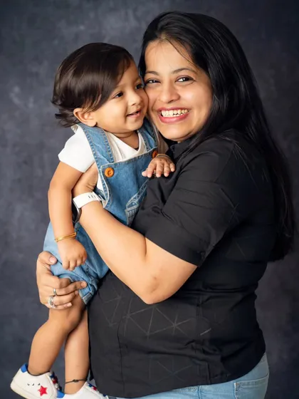 A big, happy squeeze from mom. This photo is full of laughter and love, showcasing the fun and joyful side of family life.
