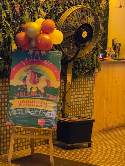 A unicorn-themed welcome sign at the entrance of a cafe, showing how we can decorate any venue to match your party's theme.