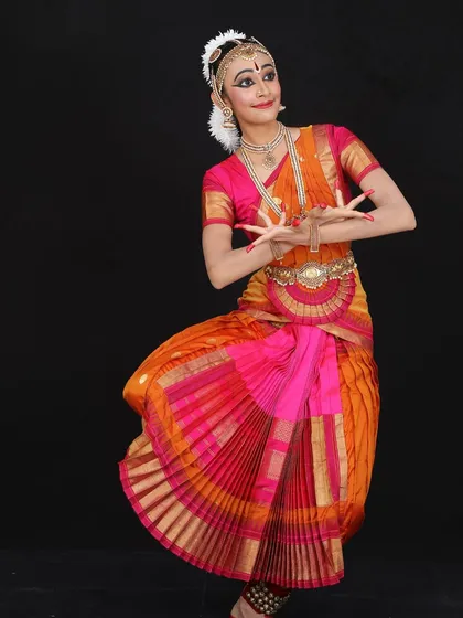 A portrait of Saira Thomas. Her dedication to the art form is visible in her graceful posture and expressive hands, which are essential for conveying meaning in dance.
