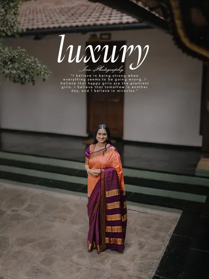 A full-length shot from the same heritage location, showing the beautiful drape of the saree in the courtyard.