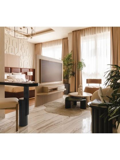 The open-plan layout of this compact apartment is designed for fluidity. A sleek, rotating TV unit acts as a versatile partition, subtly demarcating the living and bedroom areas while maintaining a sense of openness and visual connection.