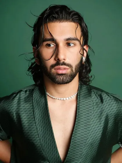Another portrait from Orry's GQ shoot. The wet-look hair and confident gaze complete the high-fashion aesthetic.