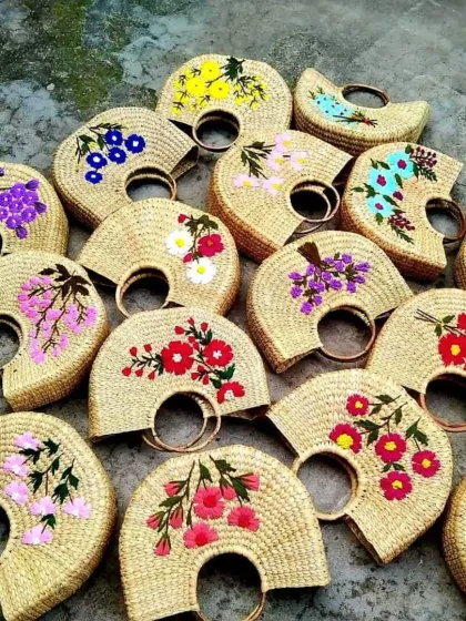 A vibrant collection of our handcrafted bags, each woven from natural fibers and adorned with unique floral embroidery. This showcases the beautiful artistry and variety our skilled artisans bring to every piece, making each bag a one-of-a-kind fashion statement.