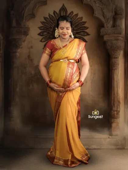 A front-facing portrait highlighting the intricate details of the saree and traditional jewelry. This pose is perfect for showcasing the complete look of a South Indian baby shower photoshoot.