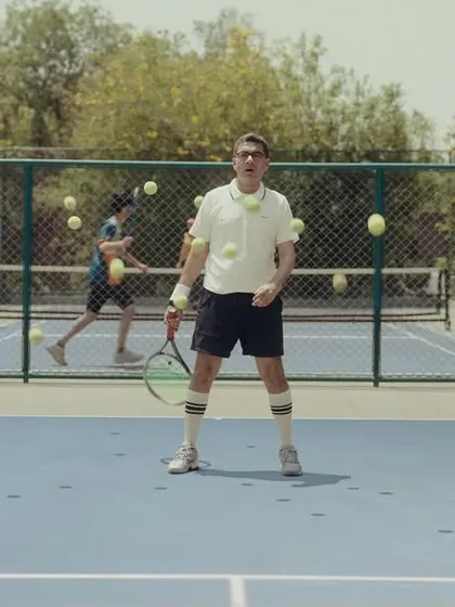 The tennis player character getting bombarded with balls, a visual metaphor for market noise. The retro sportswear adds to the quirky humor.