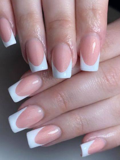 A classic French manicure on square-shaped nails with a shimmery pink base for a subtle touch of glamour.