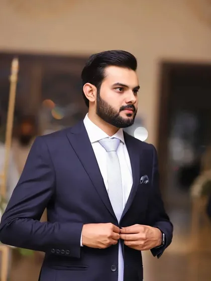 A classic reception look with a modern twist. The slim-fit suit and clean-shaven look are timeless, while the tie adds a touch of contemporary style.