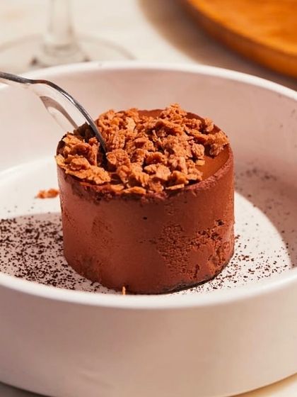 Our Bitter Chocolate Mousse is a dessert for true chocolate lovers. The rich, intense flavor is balanced by a light, airy texture and a crunchy topping, making it an elegant end to any meal.