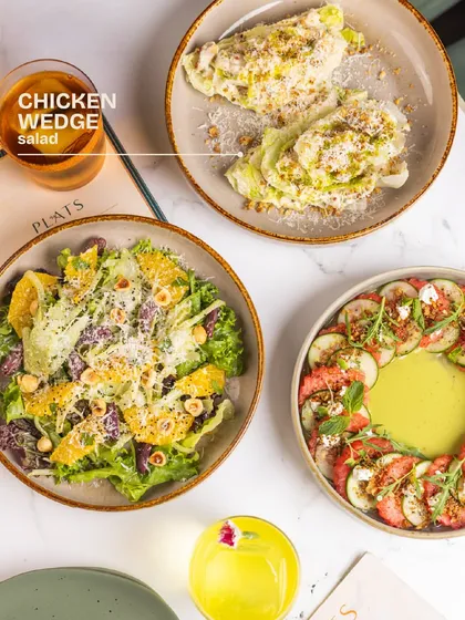 Focusing on the Chicken Wedge salad, with its creamy dressing and generous topping of parmesan crumble.