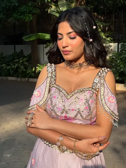 A full view of this dreamy Mehendi-carnival look. The pastel outfit, floral hair, and soft makeup come together to create a truly magical and romantic style.