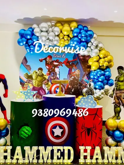 We assemble the ultimate superhero party for your little hero. This Avengers-themed setup for Mohammed Hammad features life-sized cutouts of Spider-Man and the Hulk, pedestals with iconic superhero logos, and a dynamic balloon arch in classic Avengers colors.