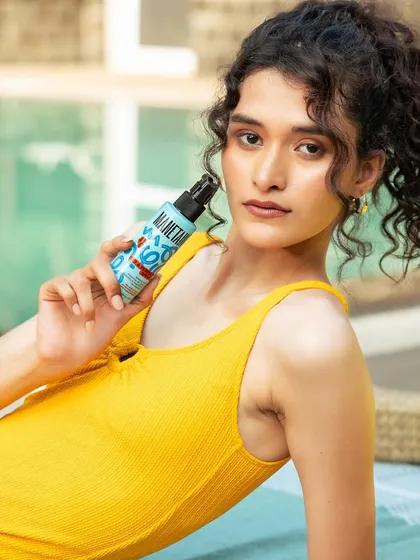 Another shot from the sunkissed series. The makeup is subtle, designed to look like the model has just spent a day by the pool, with a natural, healthy radiance.
